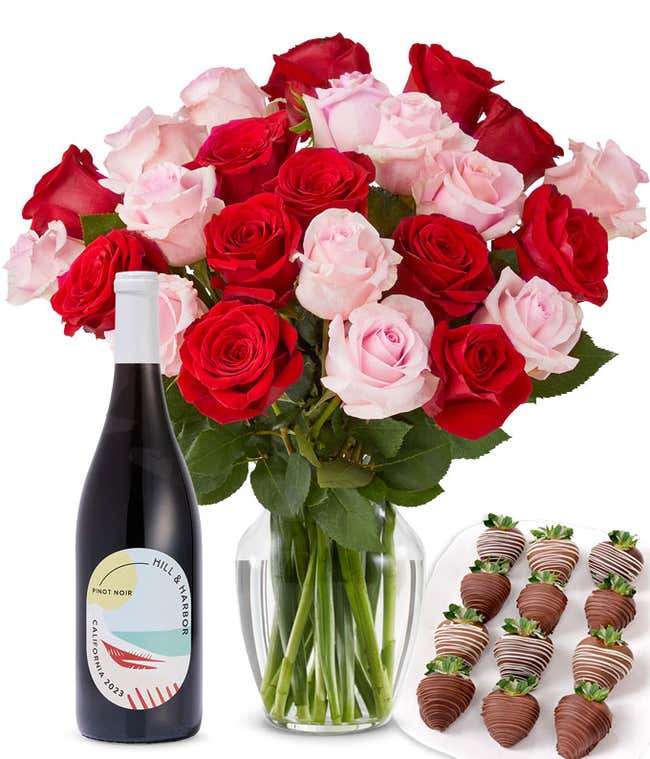 A mixed bouquet of 2 dozen red and blush roses in a clear vase is paired with a bottle of Hill &amp; Harbor Pinot Noir and 12 chocolate-covered strawberries.