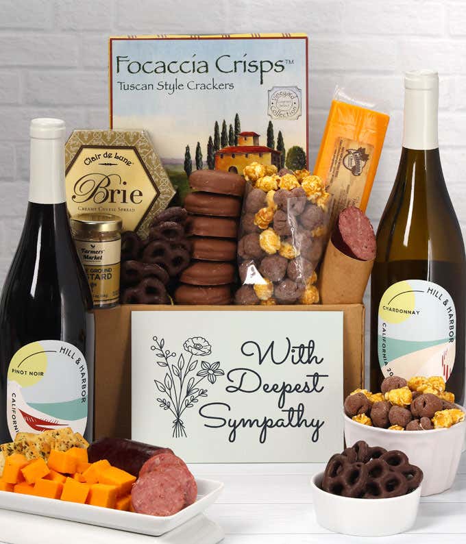 A gift set featuring two bottles of Hill & Harbor wine - white and red, focaccia crisps, two cheeses, mustard, summer sausage, caramel popcorn, chocolate pretzels, six chocolate-covered Oreos and a Sympathy card to show your support.