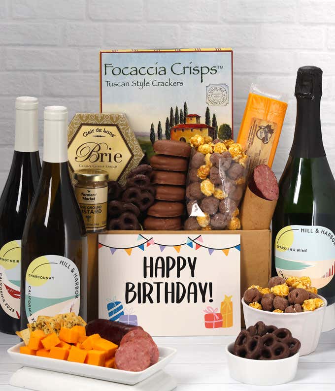 A gift set featuring a trio of California wines - red, white, and sparkling, focaccia crisps, two cheeses, mustard, summer sausage, caramel popcorn, chocolate pretzels, six chocolate-covered Oreos and a Birthday card to complete the gourmet experience.
