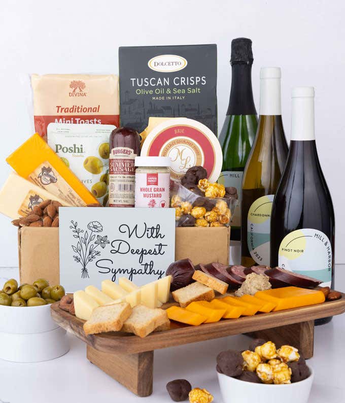 A wine and cheese gift set featuring 3 bottles of Hill & Harbor wine - red, white and sparkling. Includes a variety of gourmet cheeses, crackers, olives, almonds, sausage, and condiments finished with a Sympathy Card.