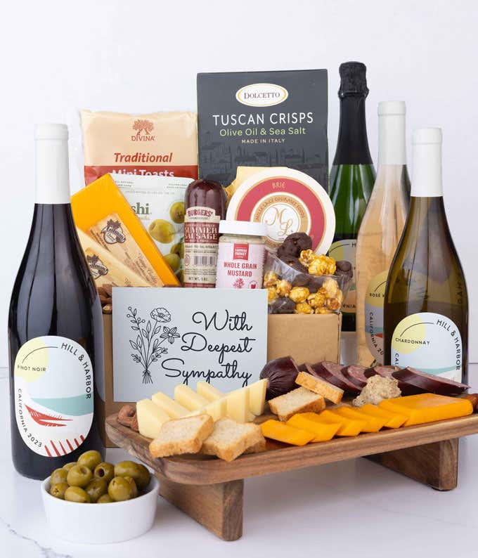 A wine and cheese gift set featuring 4 bottles of Hill & Harbor wine - red, white, rosé and sparkling. Includes a variety of gourmet cheeses, crackers, olives, almonds, sausage, and condiments finished with a Sympathy Card.