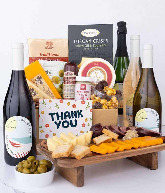 A wine and cheese gift set featuring 4 - bottles of Hill &amp; Harbor wine - sparkling, white, ros&eacute; and red. Includes a variety of gourmet cheeses, crackers, olives, summer sausage, almonds, and condiments finished with a Thank You card.