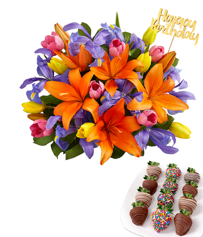 Partial image of Bright bouquet of orange lilies, purple irises, and multicolored tulips in a clear glass vase with a gold Happy Birthday pick, paired with a plate of chocolate-covered strawberries featuring swizzled and rainbow sprinkle designs. without vase.